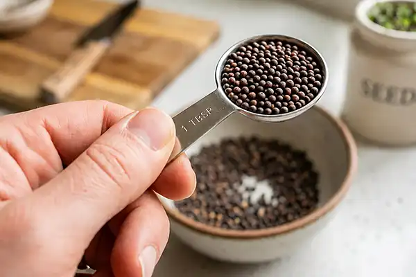 Measuring broccoli microgreen seeds for a growing tray